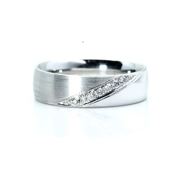 Silver ring with a diagonal line of diamonds on a brushed band