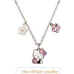 Silver chain necklace with a Hello Kitty pendant flanked by pink and purple flowers and a pink butterfly charm on the chain.